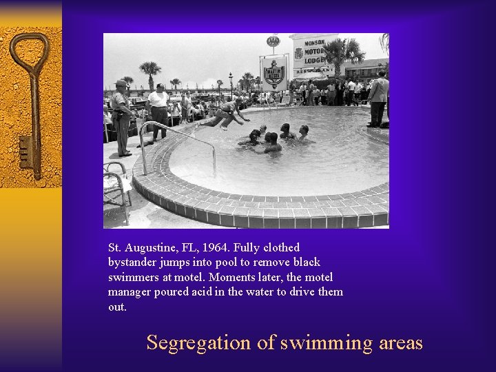 St. Augustine, FL, 1964. Fully clothed bystander jumps into pool to remove black swimmers