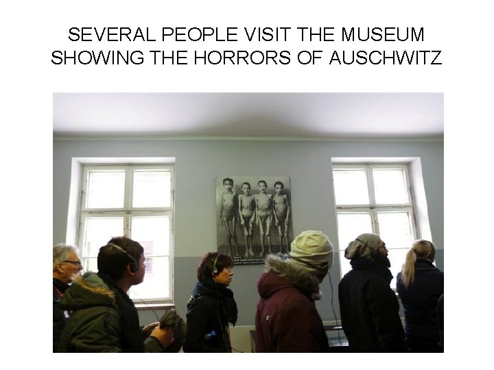 SEVERAL PEOPLE VISIT THE MUSEUM SHOWING THE HORRORS OF AUSCHWITZ 