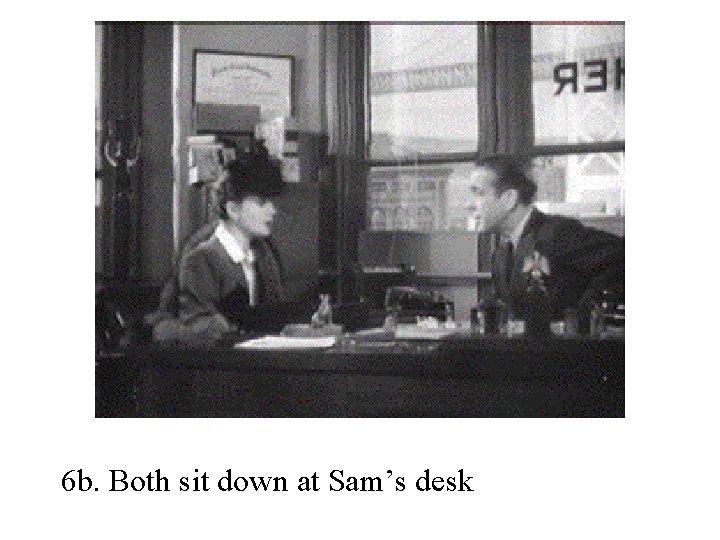 6 b. Both sit down at Sam’s desk 