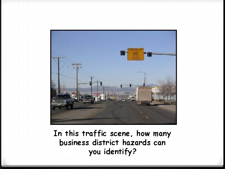 In this traffic scene, how many business district hazards can you identify? 