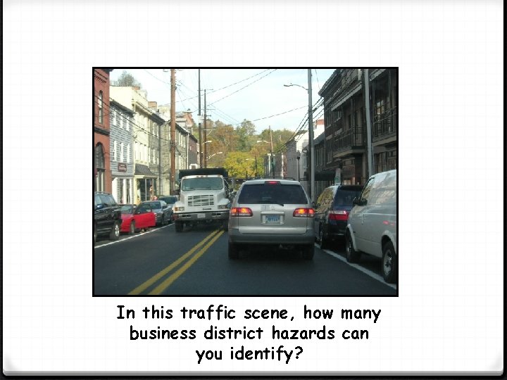 In this traffic scene, how many business district hazards can you identify? 