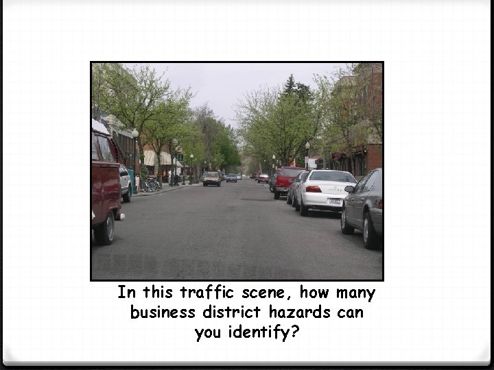 In this traffic scene, how many business district hazards can you identify? 