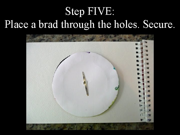 Step FIVE: Place a brad through the holes. Secure. 