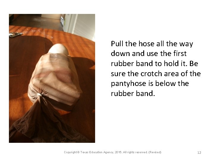 Pull the hose all the way down and use the first rubber band to