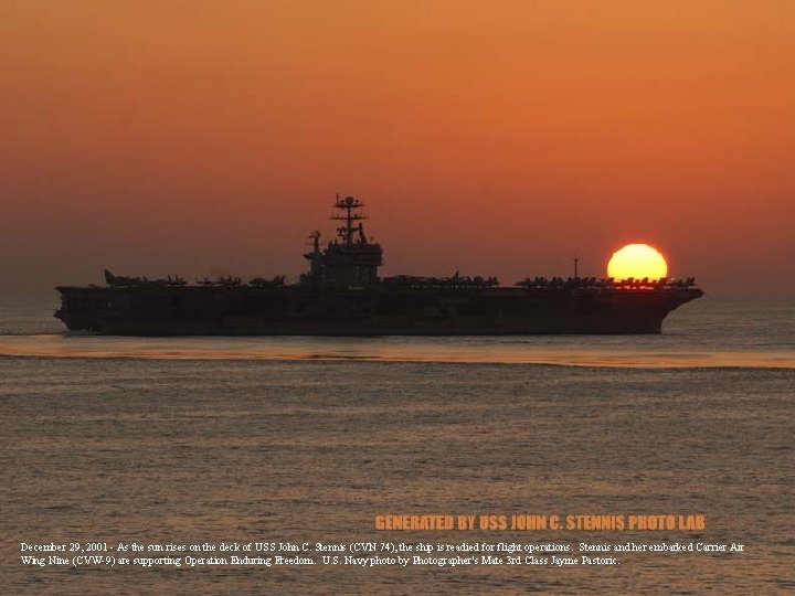 December 29, 2001 - As the sun rises on the deck of USS John