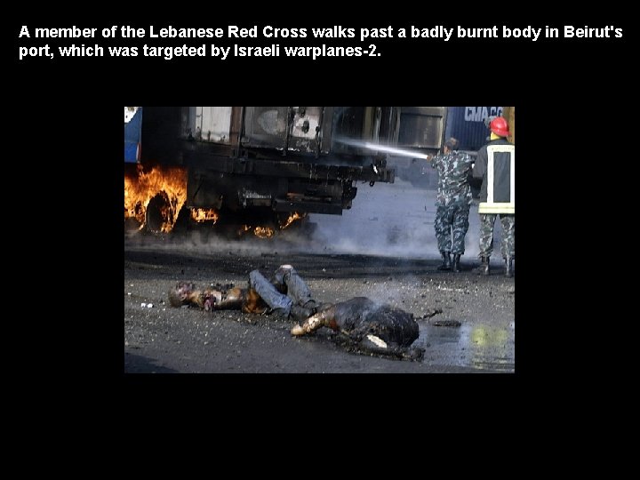 A member of the Lebanese Red Cross walks past a badly burnt body in