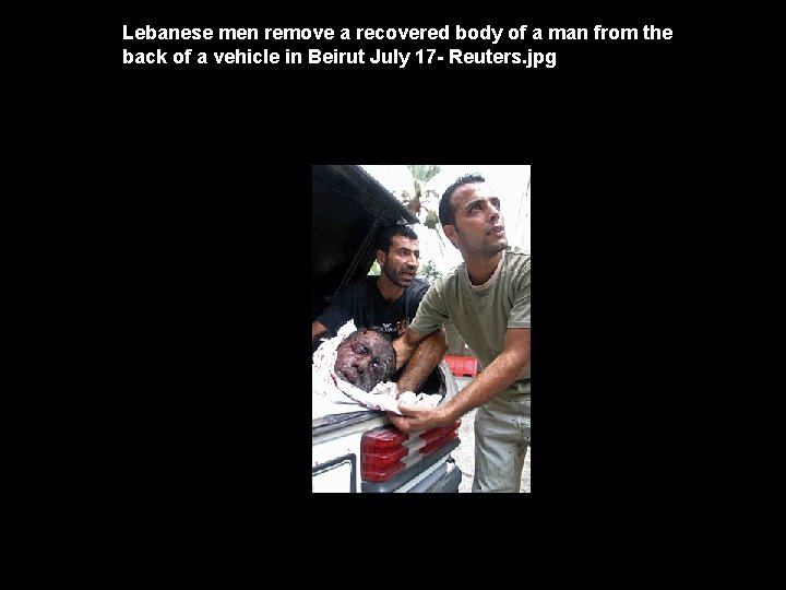 Lebanese men remove a recovered body of a man from the back of a