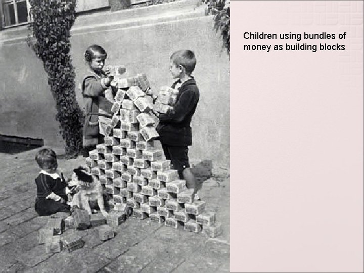Children using bundles of money as building blocks 