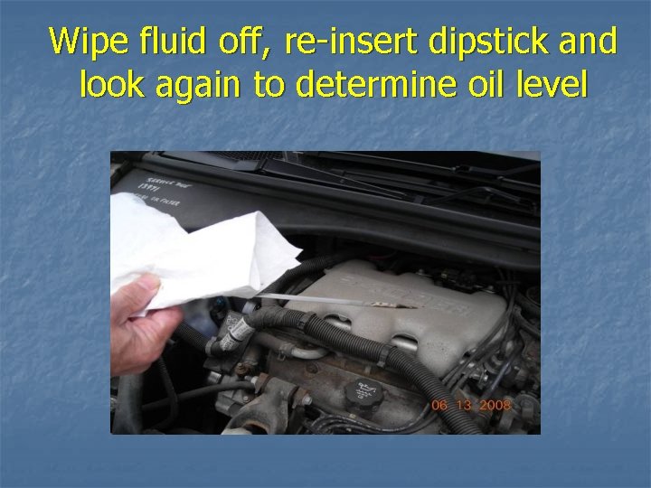 Wipe fluid off, re-insert dipstick and look again to determine oil level 