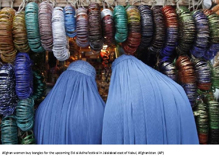 Afghan women buy bangles for the upcoming Eid al Adha festival in Jalalabad east