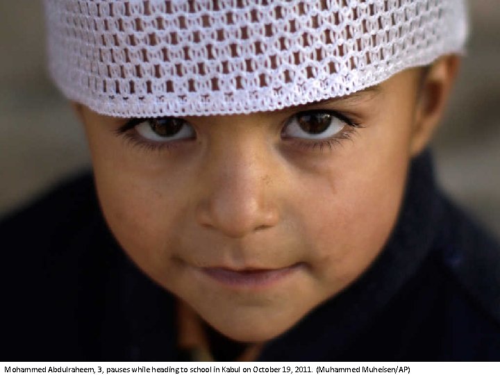 Mohammed Abdulraheem, 3, pauses while heading to school in Kabul on October 19, 2011.