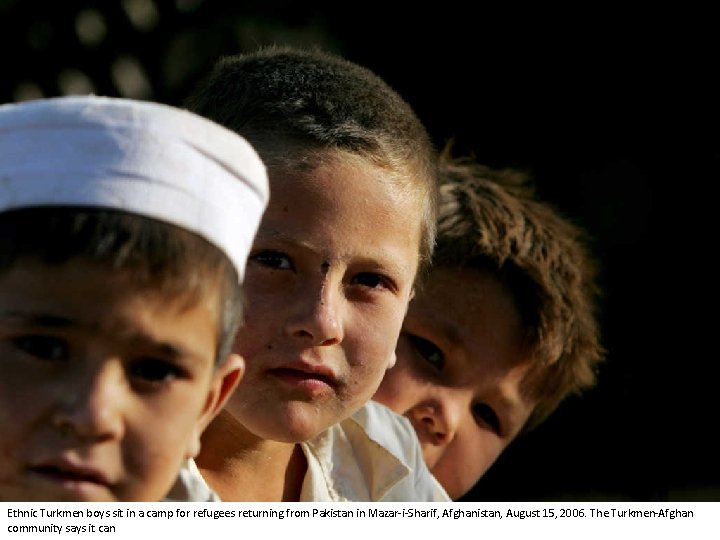 Ethnic Turkmen boys sit in a camp for refugees returning from Pakistan in Mazar-i-Sharif,