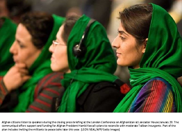 Afghan citizens listen to speakers during the closing press briefing at the London Conference