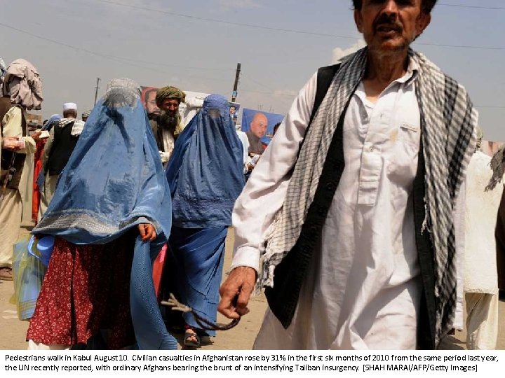 Pedestrians walk in Kabul August 10. Civilian casualties in Afghanistan rose by 31% in