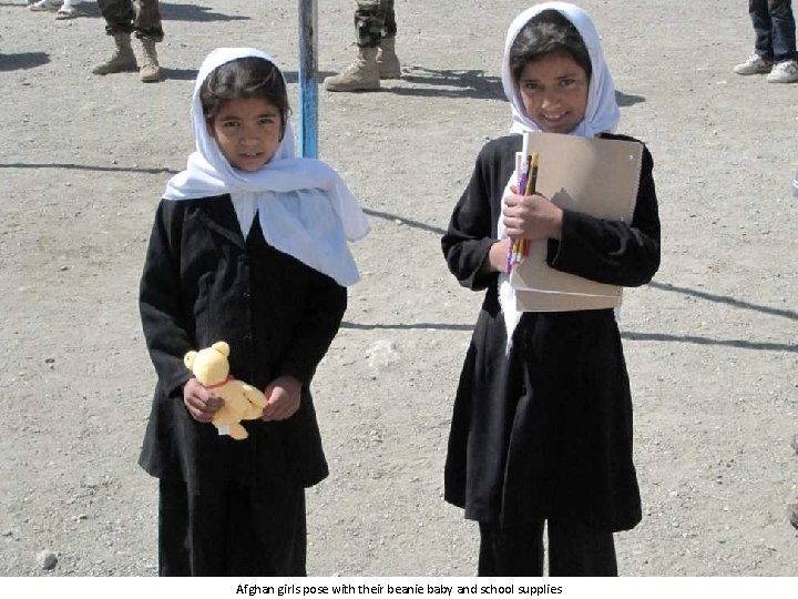 Afghan girls pose with their beanie baby and school supplies 