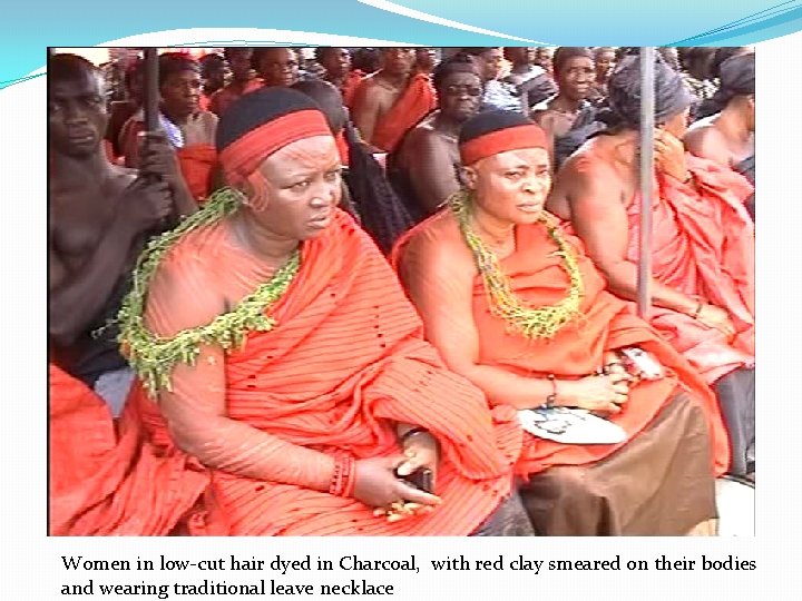 Women in low-cut hair dyed in Charcoal, with red clay smeared on their bodies