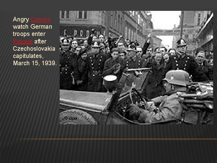 Angry Czechs watch German troops enter Prague after Czechoslovakia capitulates, March 15, 1939. 