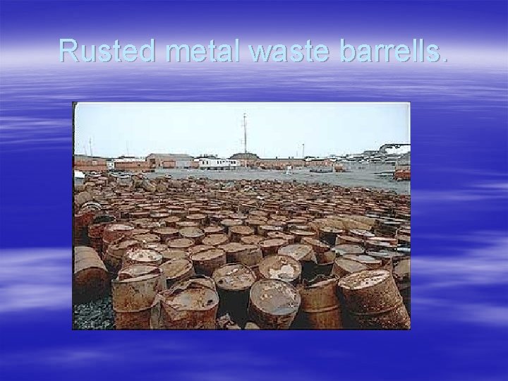 Rusted metal waste barrells. 