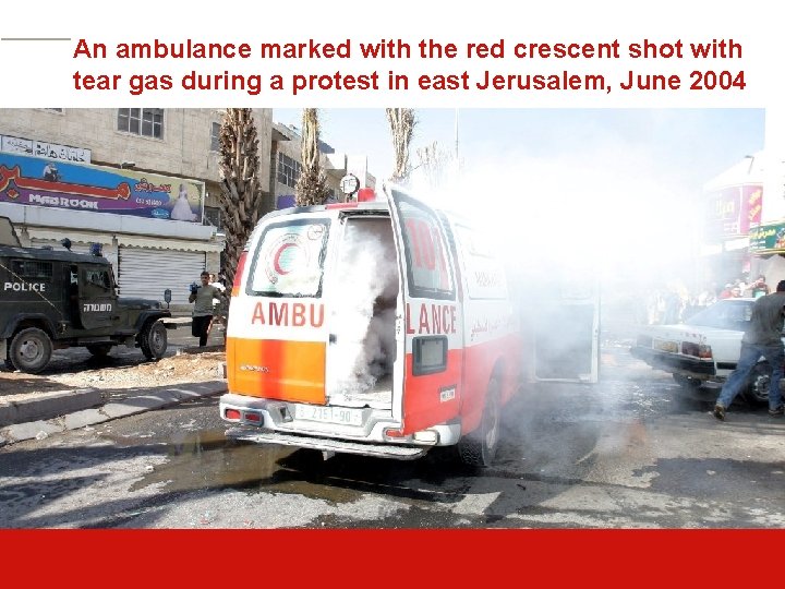 An ambulance marked with the red crescent shot with tear gas during a protest