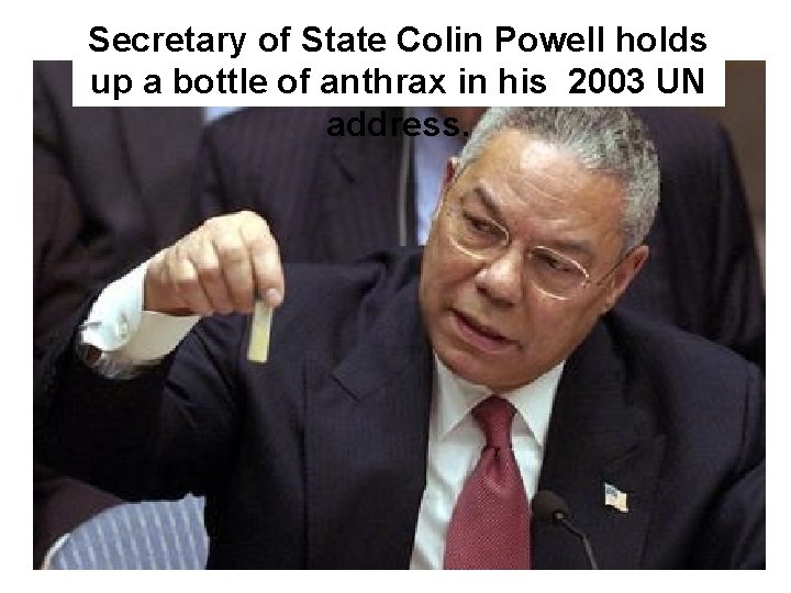 Secretary of State Colin Powell holds up a bottle of anthrax in his 2003