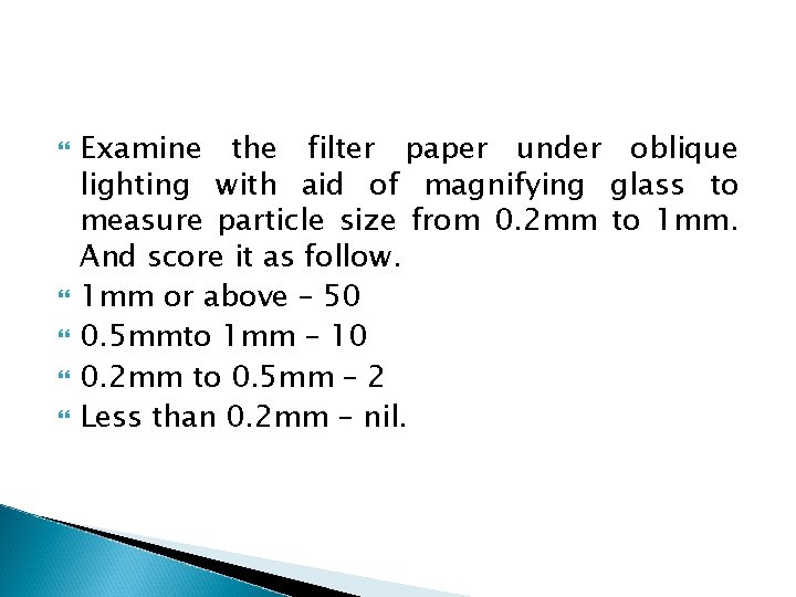  Examine the filter paper under oblique lighting with aid of magnifying glass to