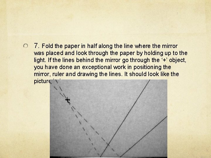 7. Fold the paper in half along the line where the mirror was placed