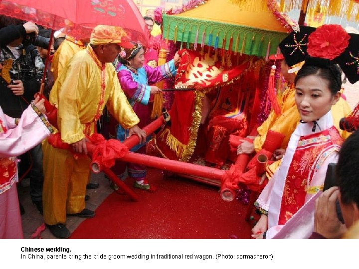 Chinese wedding. In China, parents bring the bride groom wedding in traditional red wagon.