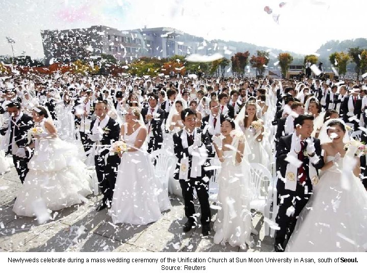 Newlyweds celebrate during a mass wedding ceremony of the Unification Church at Sun Moon