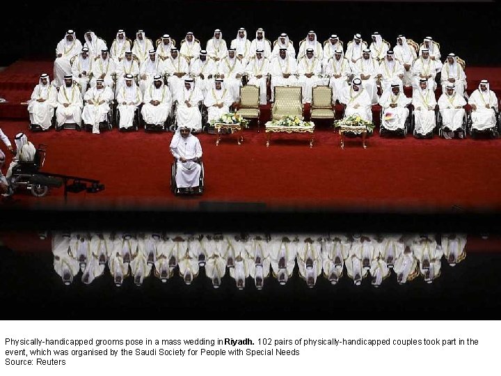 Physically-handicapped grooms pose in a mass wedding in Riyadh. 102 pairs of physically-handicapped couples