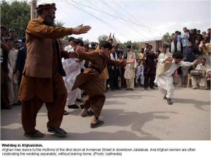 Wedding in Afghanistan. Afghan men dance to the rhythms of the dhol drum at