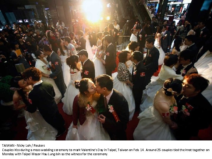 TAIWAN - Nicky Loh / Reuters Couples kiss during a mass wedding ceremony to