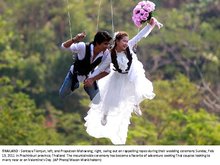 THAILAND - Sontaya Tiemjun, left, and Praputson Mahavong, right, swing out on rappelling ropes