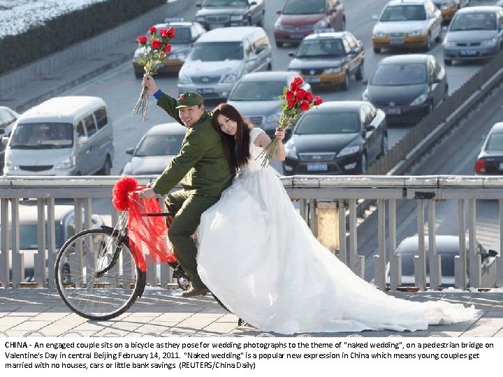 CHINA - An engaged couple sits on a bicycle as they pose for wedding