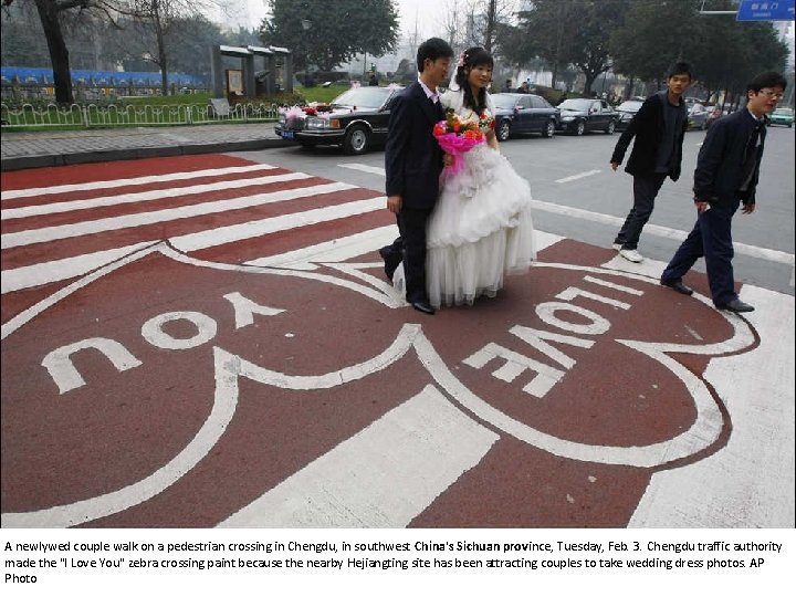 A newlywed couple walk on a pedestrian crossing in Chengdu, in southwest China's Sichuan