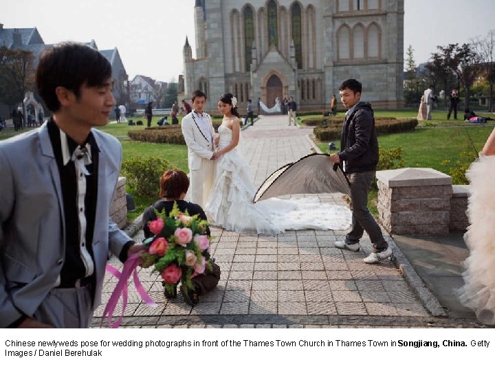 Chinese newlyweds pose for wedding photographs in front of the Thames Town Church in