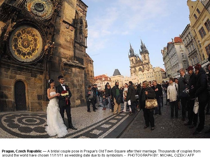 Prague, Czech Republic — A bridal couple pose in Prague's Old Town Square after