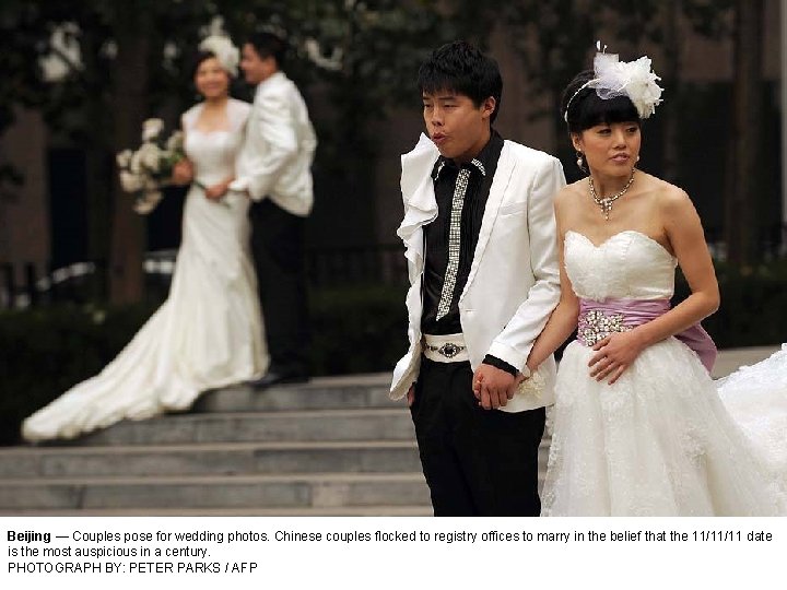 Beijing — Couples pose for wedding photos. Chinese couples flocked to registry offices to