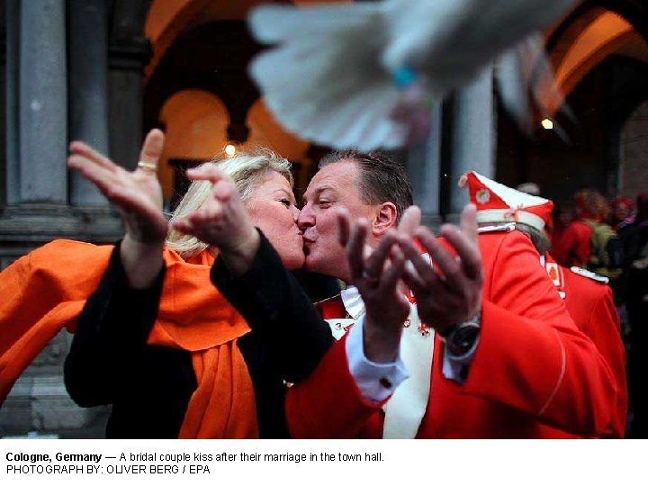 Cologne, Germany — A bridal couple kiss after their marriage in the town hall.