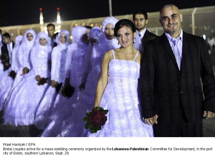 Wael Hamzeh / EPA Bridal couples arrive for a mass wedding ceremony organized by