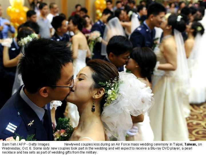 Sam Yeh / AFP - Getty Images Newlywed couples kiss during an Air Force