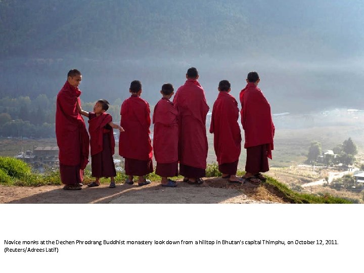 Novice monks at the Dechen Phrodrang Buddhist monastery look down from a hilltop in