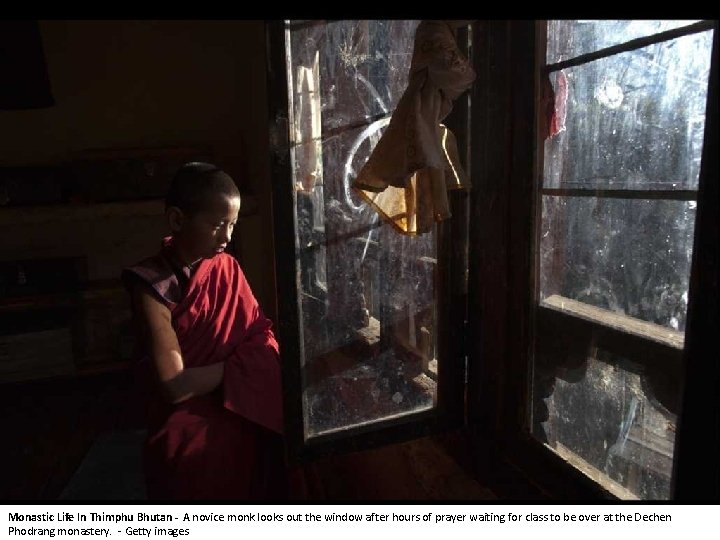 Monastic Life In Thimphu Bhutan - A novice monk looks out the window after