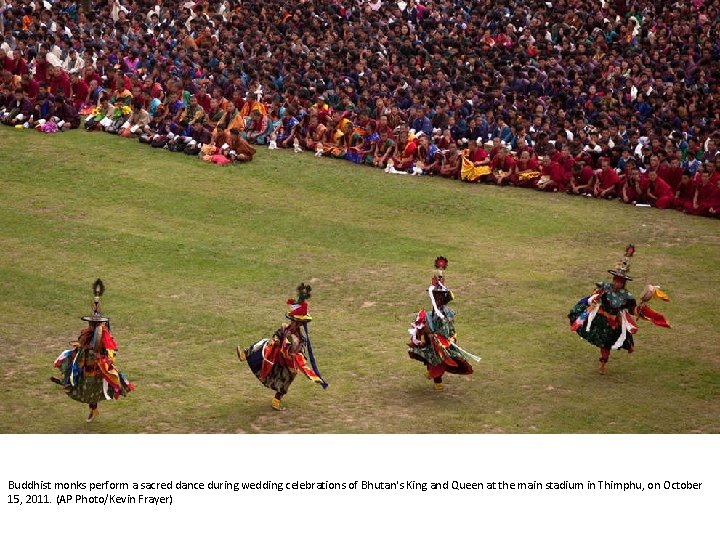 Buddhist monks perform a sacred dance during wedding celebrations of Bhutan's King and Queen