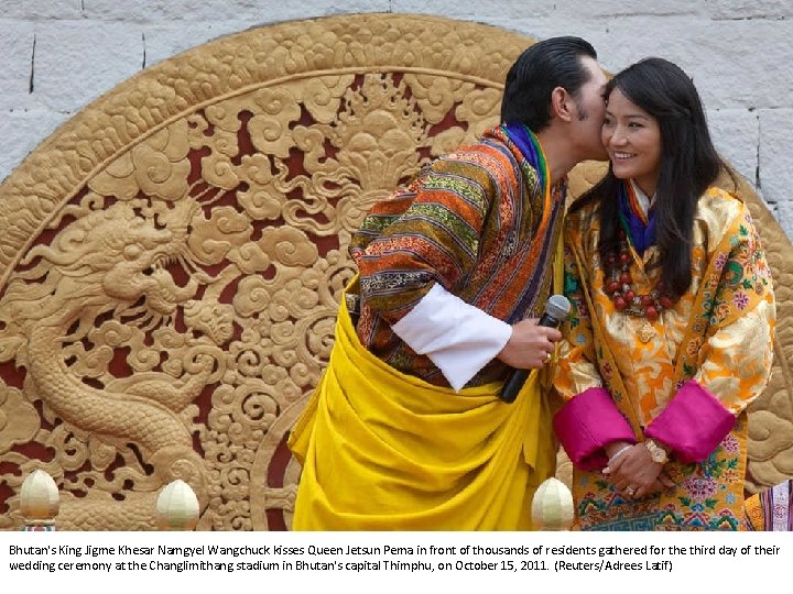 Bhutan's King Jigme Khesar Namgyel Wangchuck kisses Queen Jetsun Pema in front of thousands