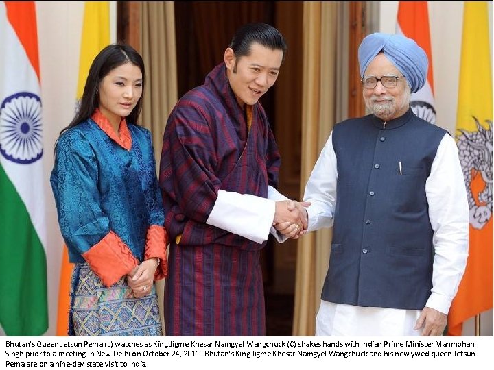 Bhutan's Queen Jetsun Pema (L) watches as King Jigme Khesar Namgyel Wangchuck (C) shakes