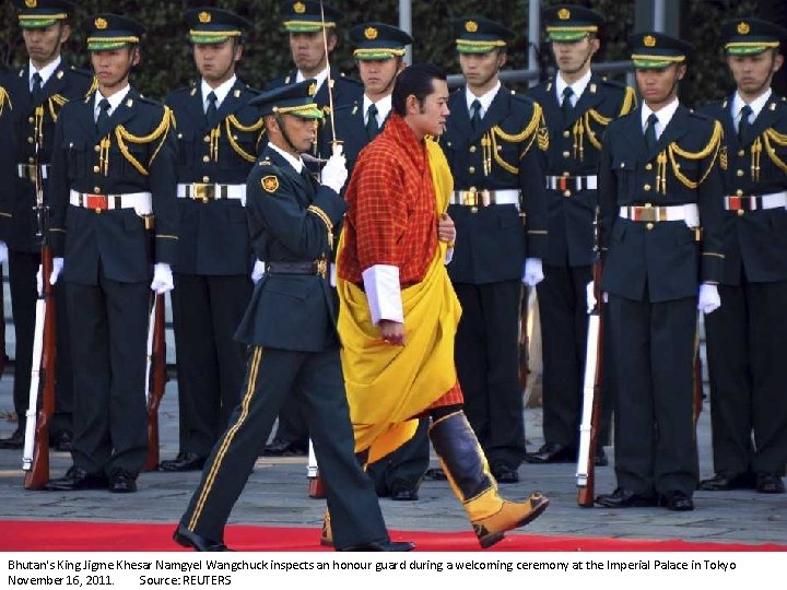 Bhutan's King Jigme Khesar Namgyel Wangchuck inspects an honour guard during a welcoming ceremony