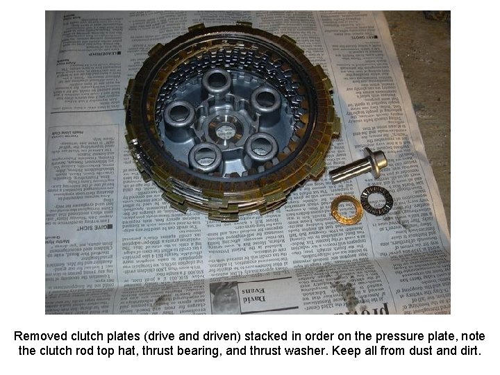 Removed clutch plates (drive and driven) stacked in order on the pressure plate, note