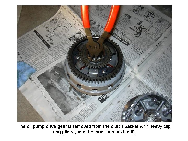 The oil pump drive gear is removed from the clutch basket with heavy clip