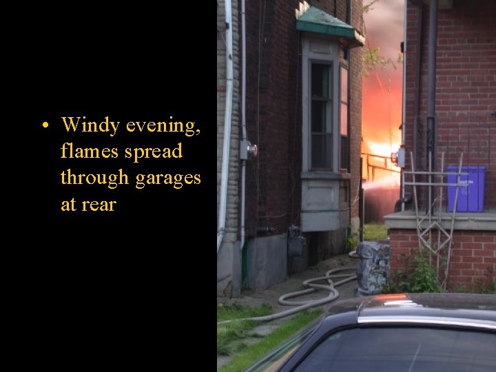  • Windy evening, flames spread through garages at rear 