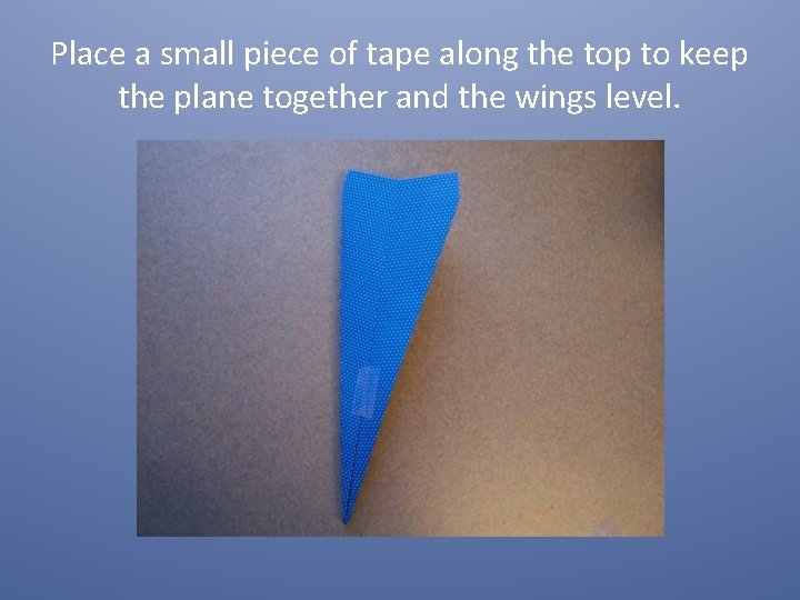 Place a small piece of tape along the top to keep the plane together